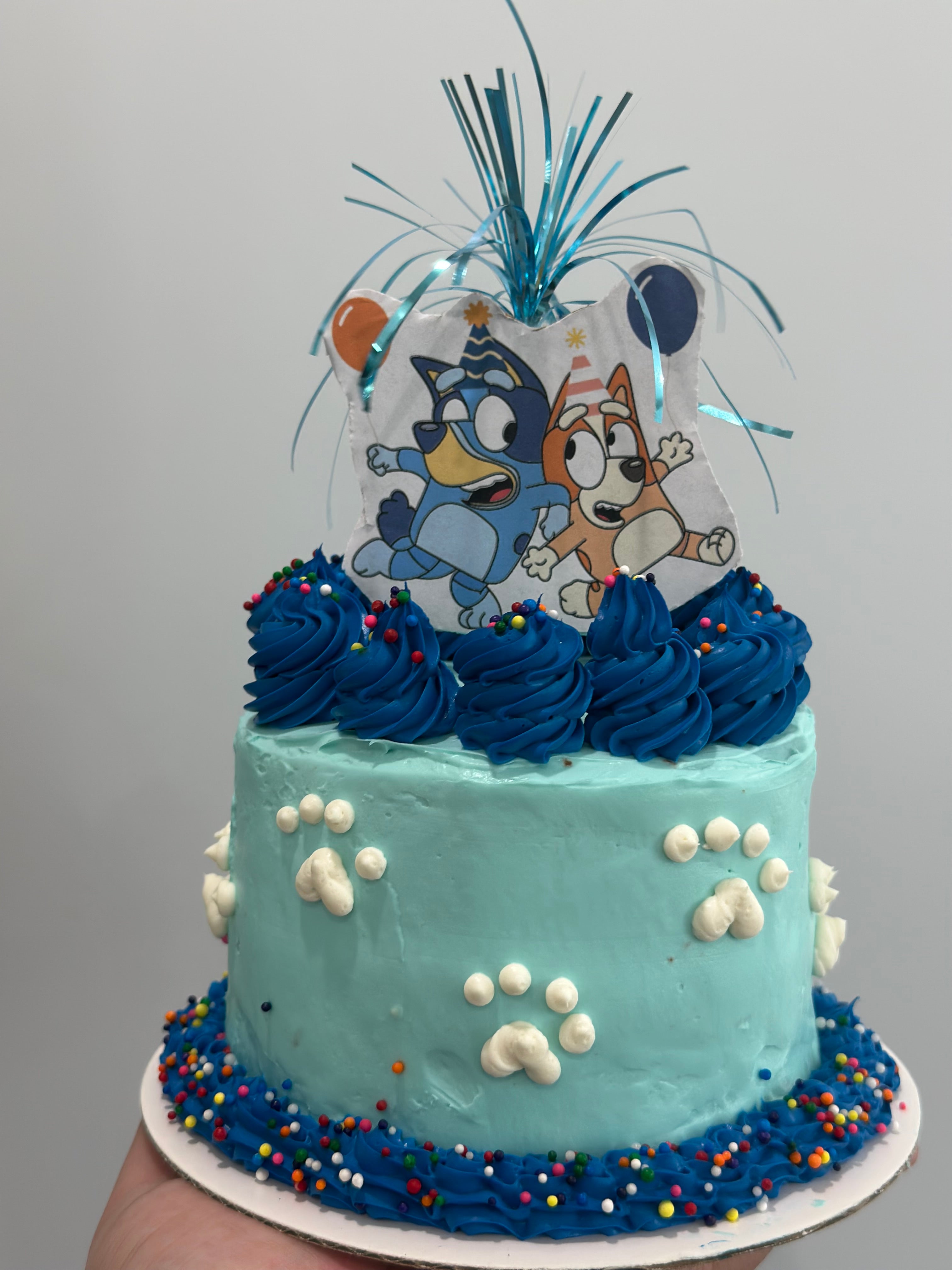 Bluey themed birthday cake! Strawberry cake with fresh strawberry filling.  Vanilla buttercream topped with chocolate dipped balls! Happy ... |  Instagram
